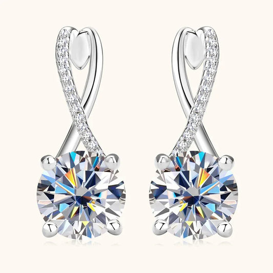 Silver-tone twisted drop earrings with round moissanite center and clear stone accents, hoop backs