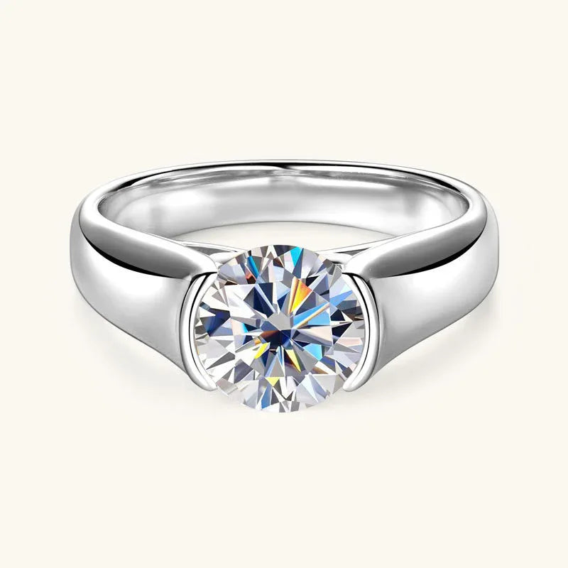 White gold-tone moissanite solitaire ring with round center stone and split prongs