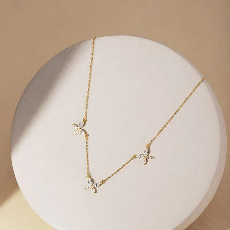 Gold butterfly CZ pendant necklace featuring three crystal butterfly pendants