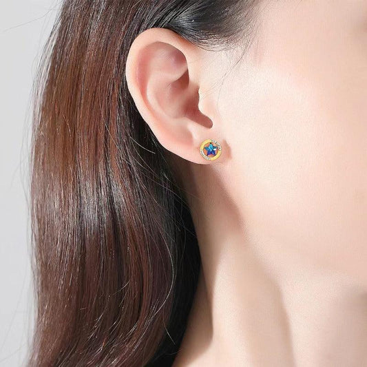 Gold star halo stud earring with blue center CZ on ear