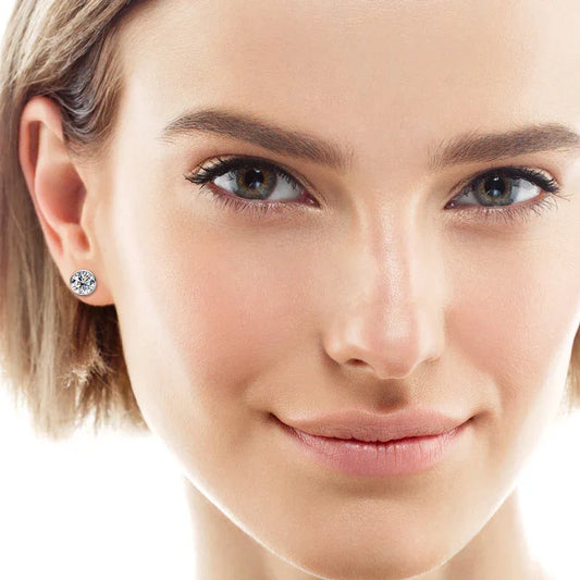 Single silver-tone round moissanite stud earring with sparkling bezel-set stone.