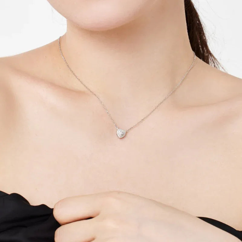 Heart pendant necklace with clear CZ center and pavé stones on a silver chain