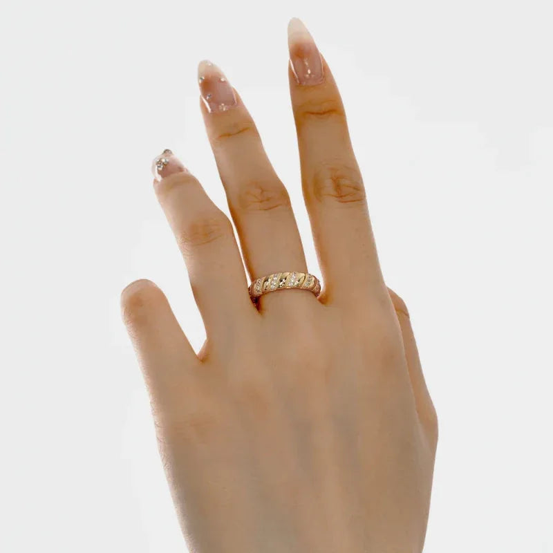 Gold twisted eternity ring with clustered CZ stones and twisted band profile