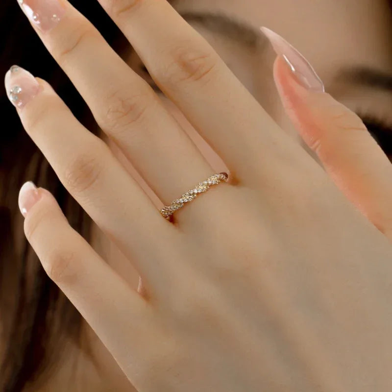 Gold twisted eternity band ring with pavé CZ stones on finger