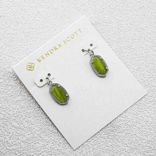 Kendra Scott cat's eye drop earrings with green oval stones and silver-tone frames