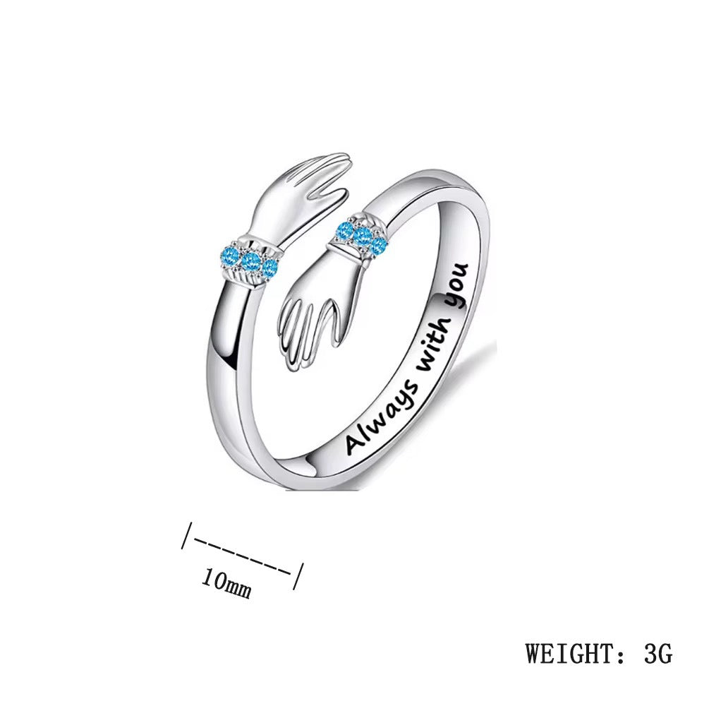 Adjustable S925 silver ring with hugging hands and blue stones, says 'Always with you'