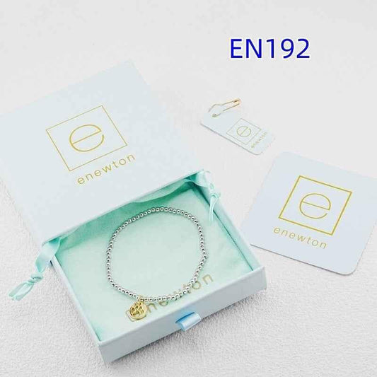 Silver beaded bracelet with round gold paw-print disc charm