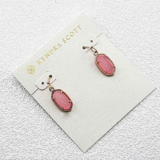 Rose gold-tone teardrop toothstone earrings with pink center on hook backs