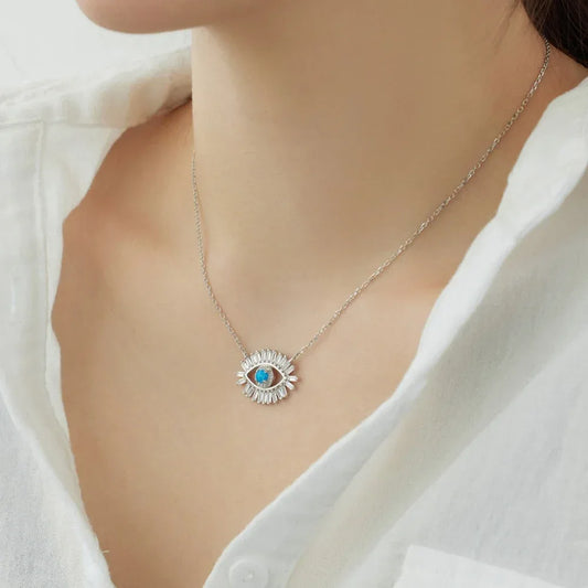Evil eye pendant necklace on a silver chain, blue center stone with CZ surround