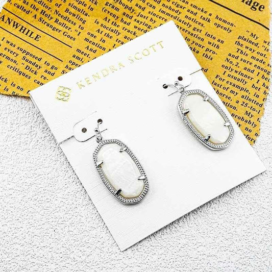 Geometric oval drop earrings with white stone in silver-tone settings