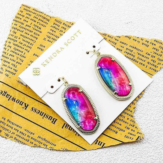 Pair of gold-tone oval rainbow crystal earrings with hook closures, shown on card