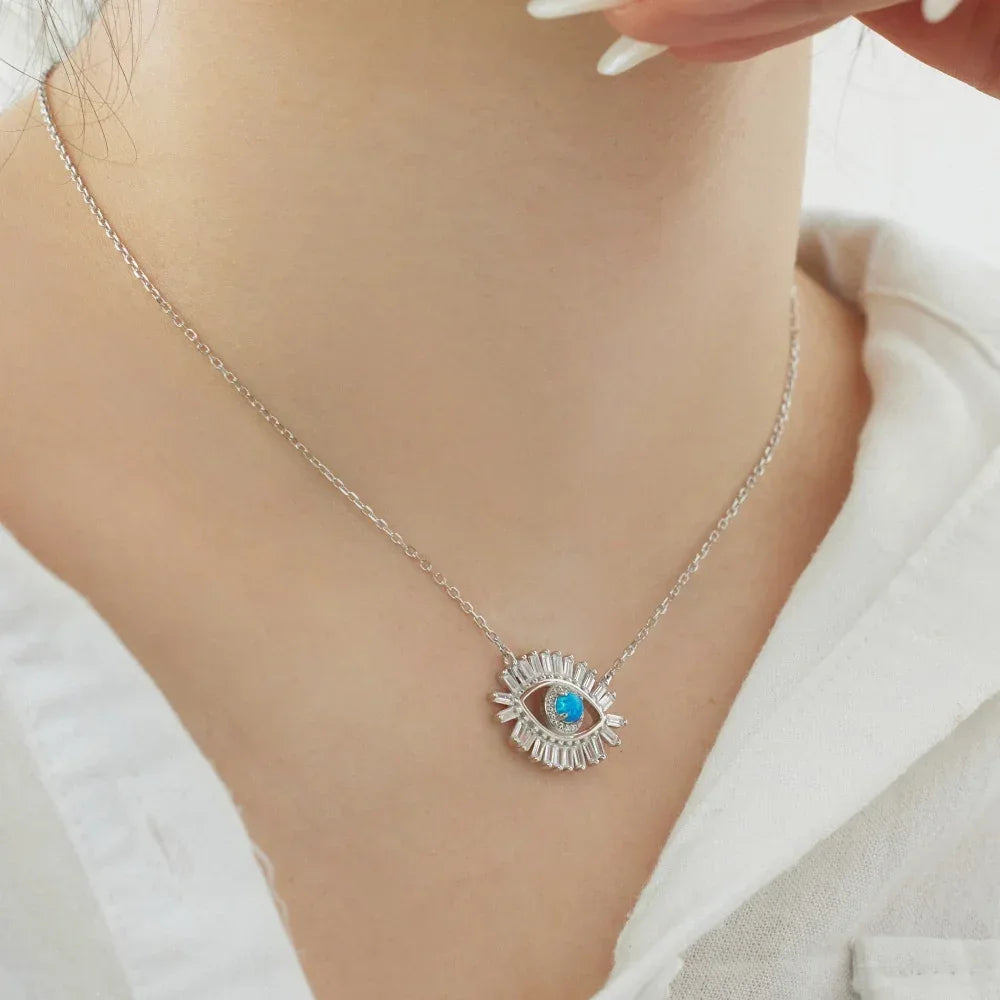 Evil eye pendant necklace with blue center stone and silver CZ rays on chain