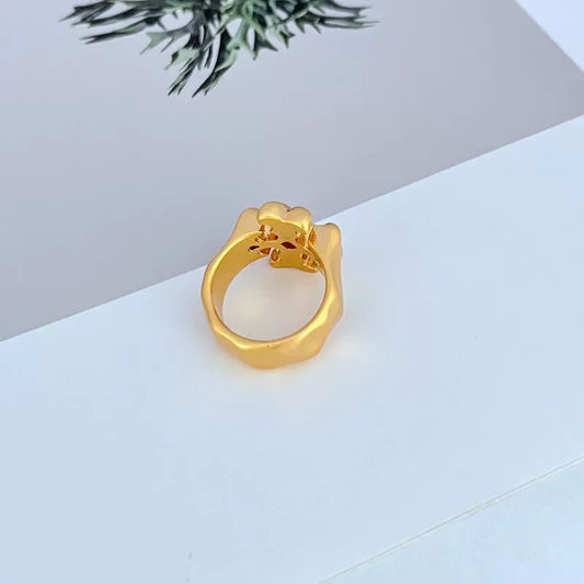 Gold Roxanne logo ring, open shank view with small crest details