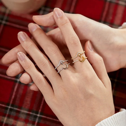 Gold-tone crescent moon charm ring with pavé band on finger