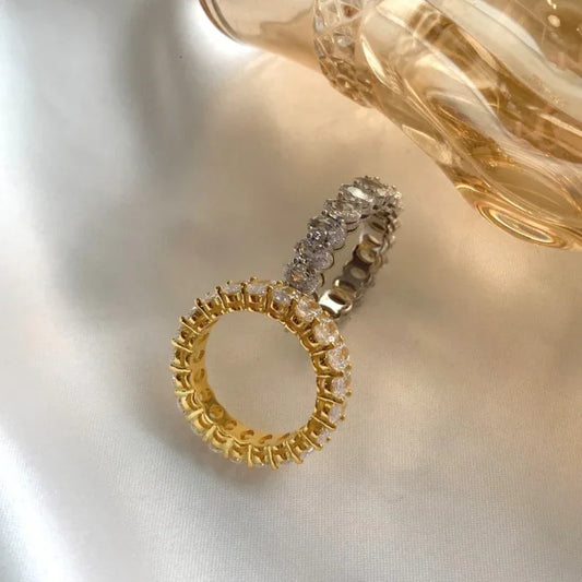 Two oval CZ love rings, gold-tone and silver-tone, with pavé stones