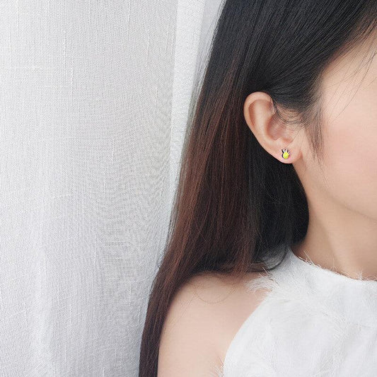Bee enamel stud earring on ear with yellow body and silver wings