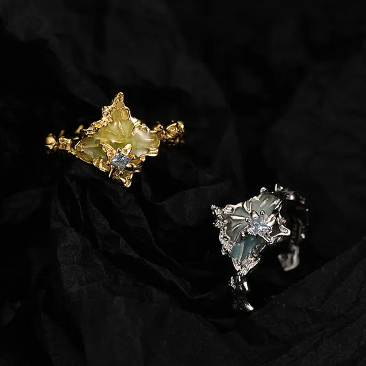 Silver textured ring with green enamel detail and blue center stone