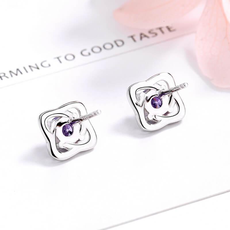 Silver four-leaf clover flower stud earrings with purple round zircon and post backs
