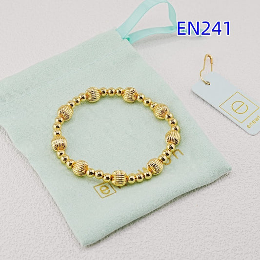 Elastic bead bracelet with gold ridged round beads and small silver accents