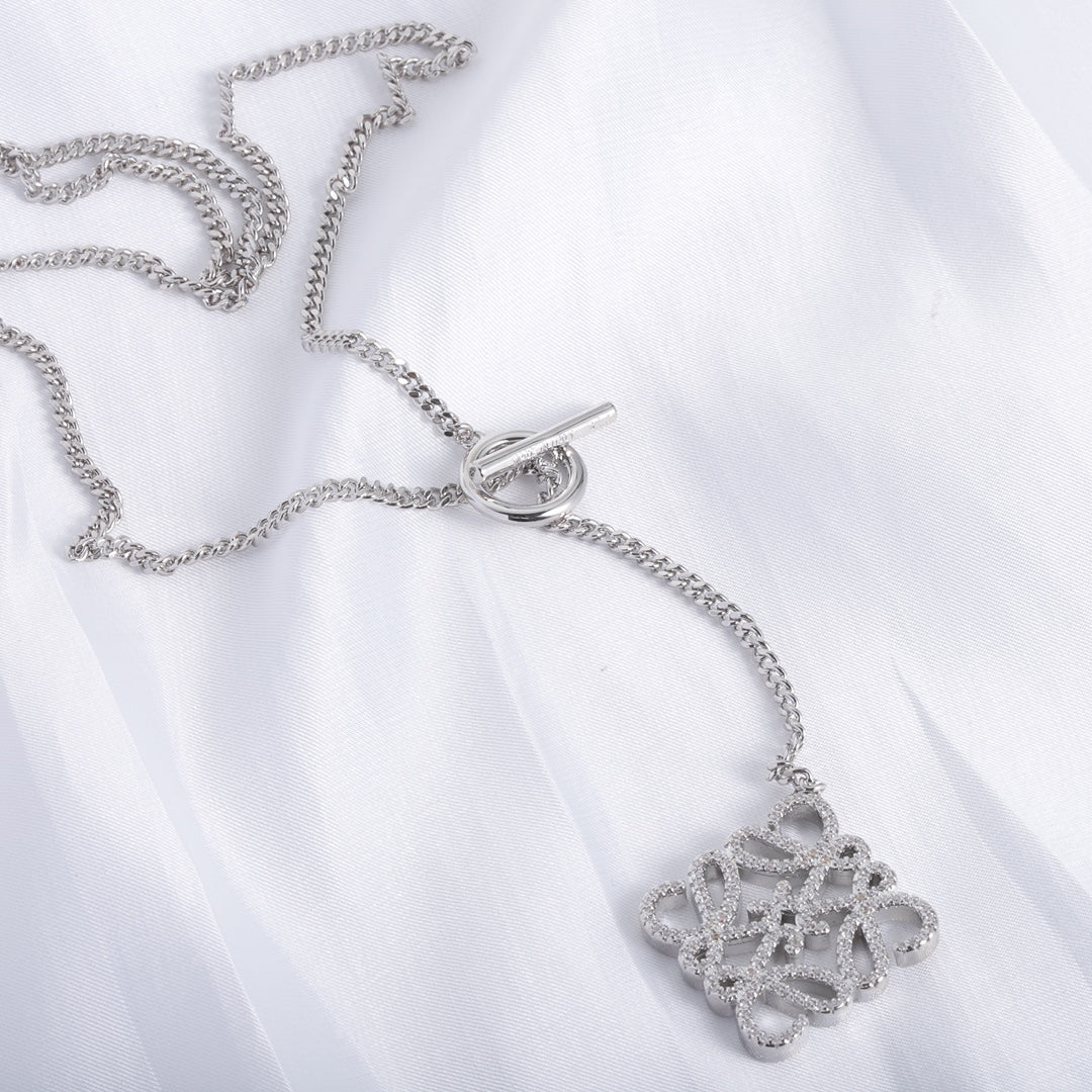 Silver chain necklace with square cutout logo pendant and O-ring clasp, close-up