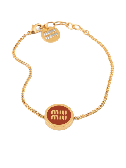 Gold chain bracelet with red enamel circular logo charm and Miu Miu text