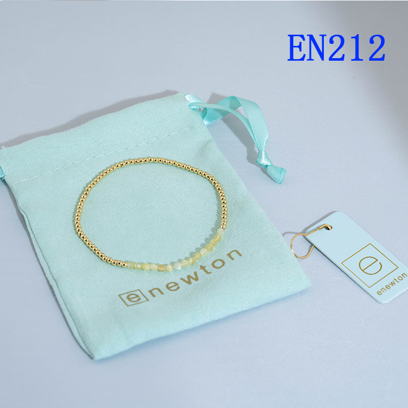 Round beaded elastic bracelet with gold-tone and light-yellow beads