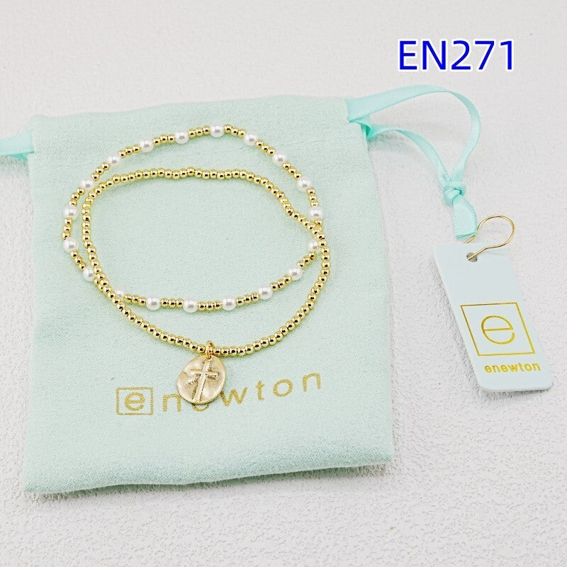 Pearl and disc cross pendant bracelet set, gold-tone beads with white pearls and charm