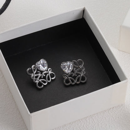 Heart stud earrings with silver-tone openwork frame and clear zircon centers