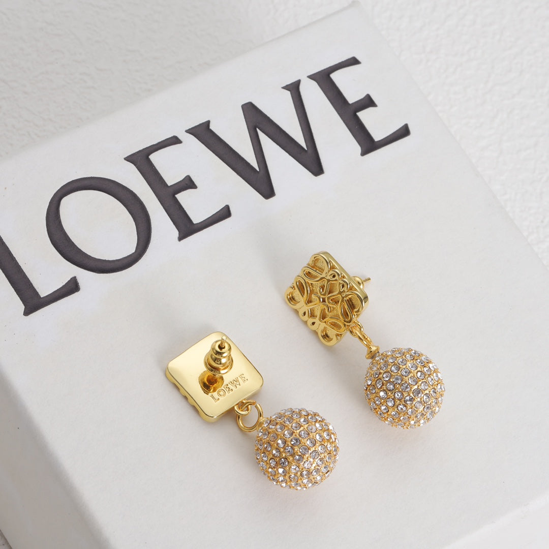 Gold square-logo earrings with round rhinestone pavé drops, close-up front