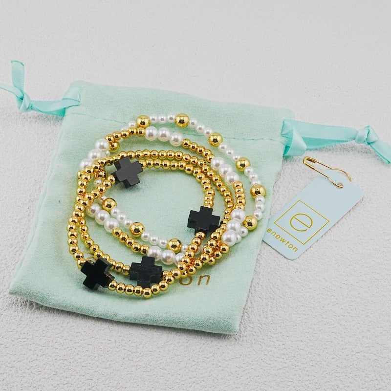 4-piece pearl and gold beaded stackable bracelets with dark cross charms