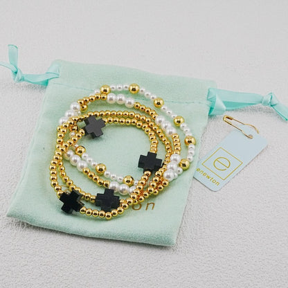 4-piece pearl and gold beaded stackable bracelets with dark cross charms