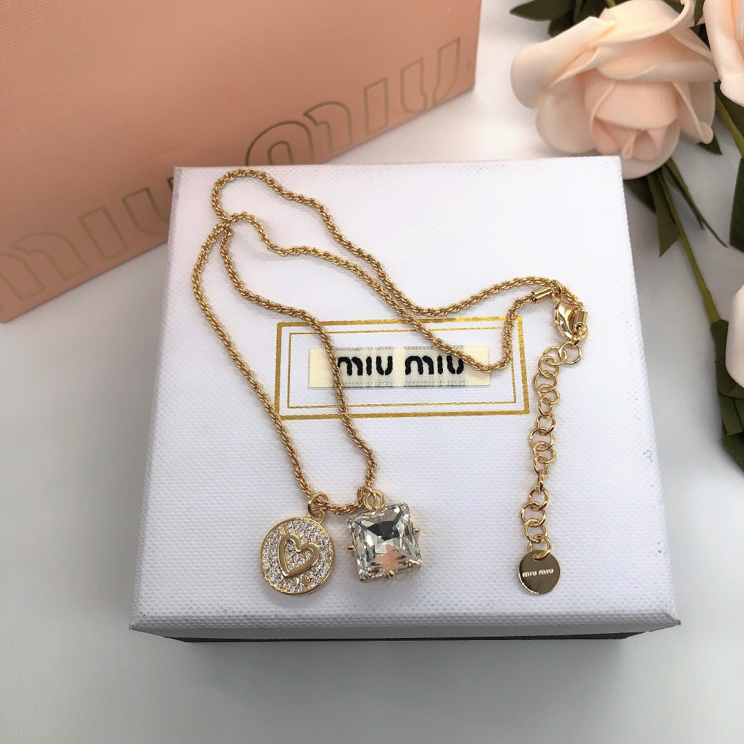 Miu Miu gold-tone pendant necklace with heart, square crystal charms and a small tag charm
