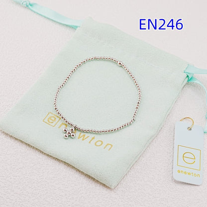 Elastic beaded cross pendant bracelet with silver-tone round beads and small charms
