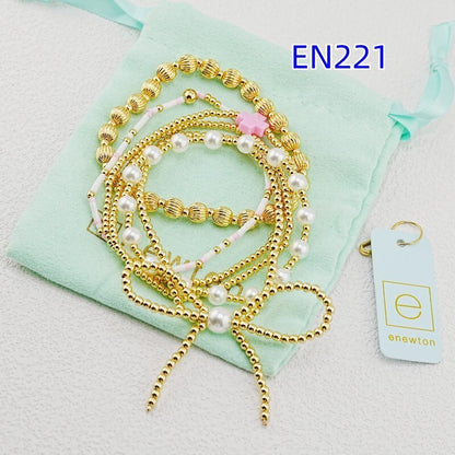 Gold-tone bracelet set with faux pearl beads, pink accent beads, and shell bead links