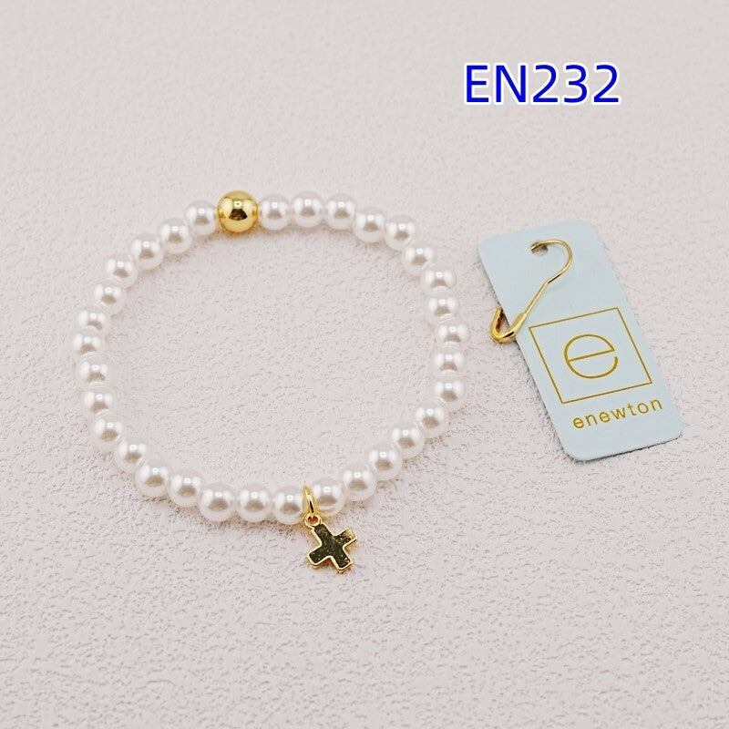 White pearl bead bracelet with gold accent bead and gold cross charm