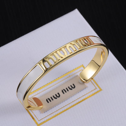 Miu Miu enamel openwork logo bangle, gold-tone cuff with white enamel panels