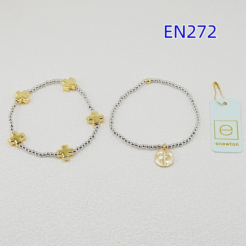 Pair of silver beaded cross bracelets with gold charms and round coin pendant.