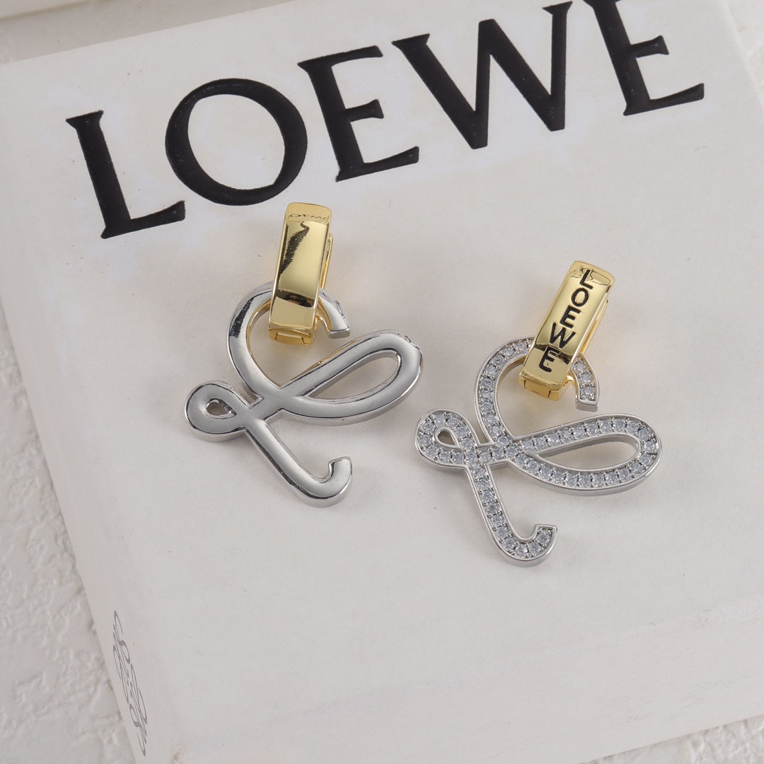 Silver logo stud earrings with openwork outline and gold hoop backing, clear stones