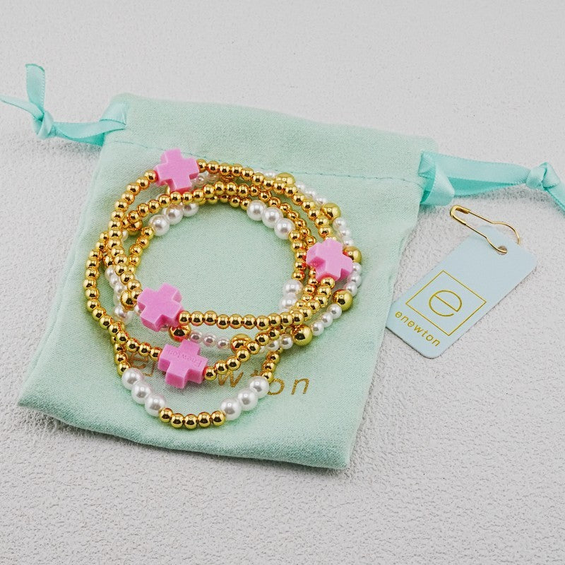 4-piece pearl and gold beaded stackable bracelets with pink cross charms
