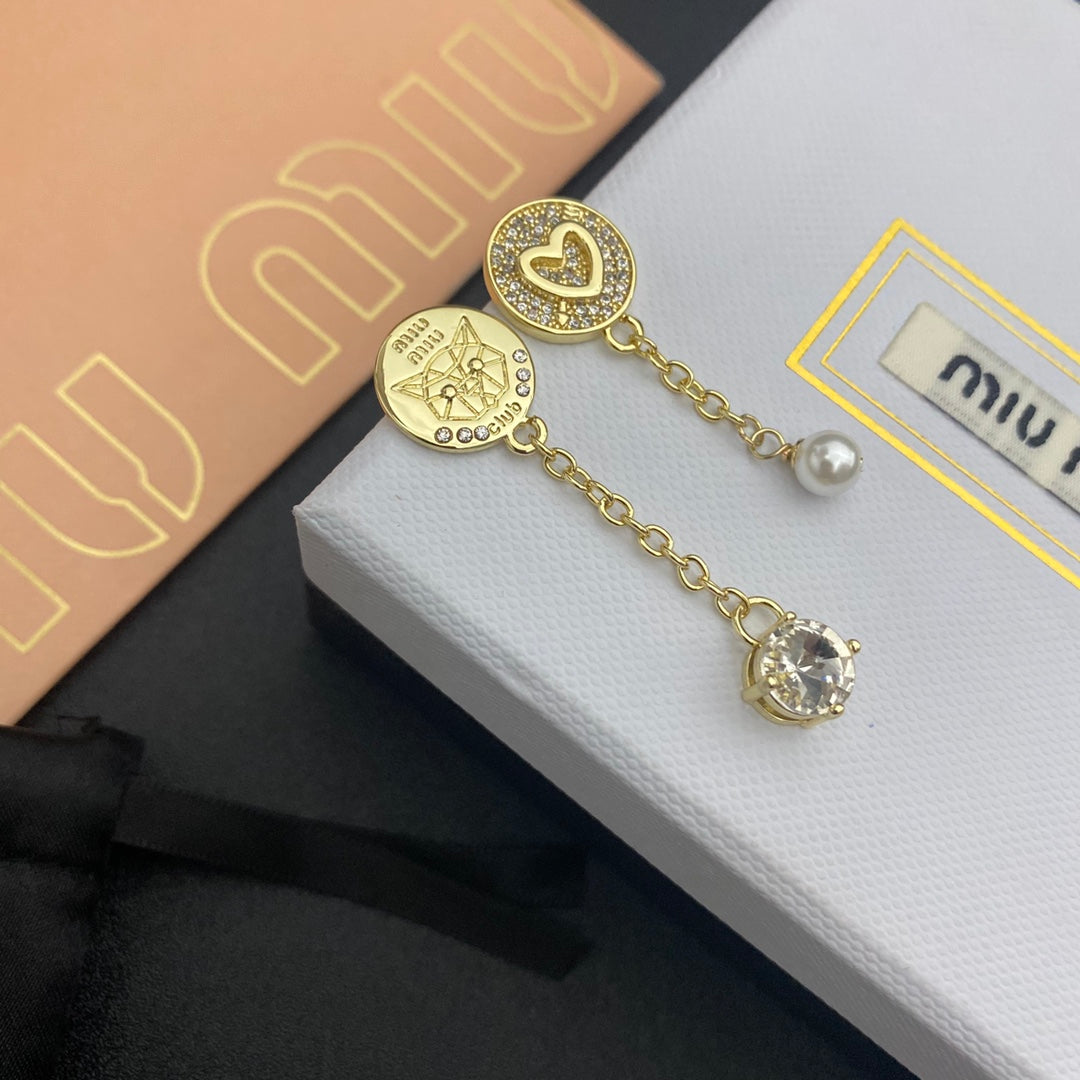 Gold earrings with pavé heart studs, pearl bead tassel, clear crystal drop