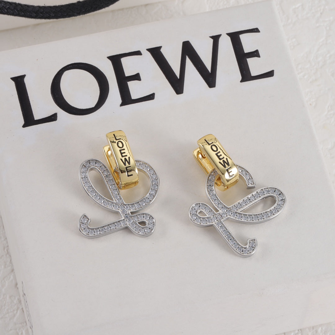 Gold and silver logo stud earrings, openwork outline with small clear stones