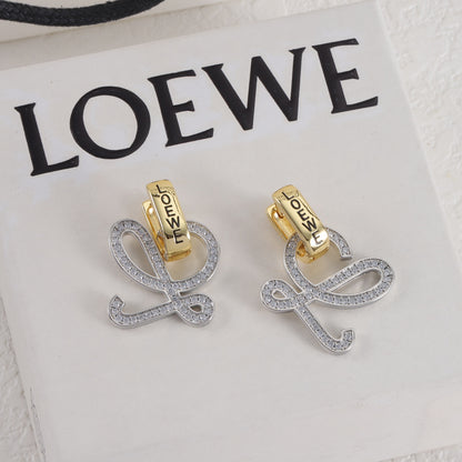 Gold and silver logo stud earrings, openwork outline with small clear stones