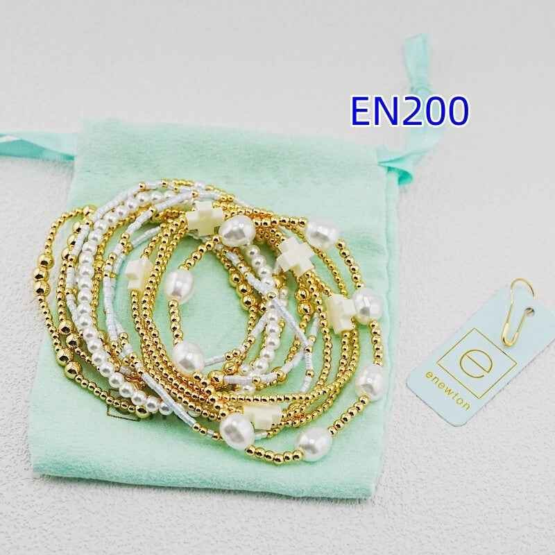 enewton 12-piece set of gold and white pearl bracelets
