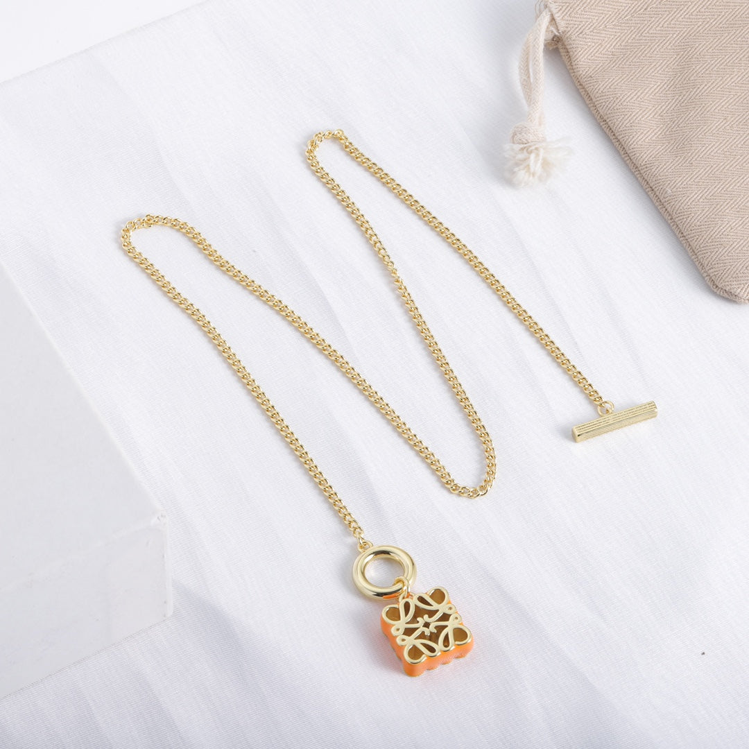 Gold-tone chain necklace with orange enamel square cutout logo pendant and ring clasp