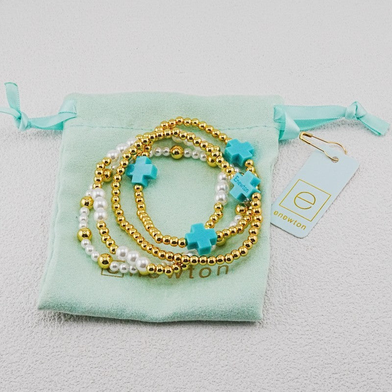 4-piece pearl and gold beaded stackable bracelets with teal cross charms