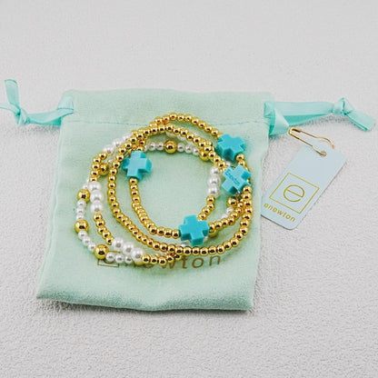 4-piece pearl and gold beaded stackable bracelets with teal cross charms