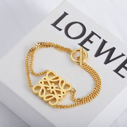 Gold chain bracelet with square cutout logo charm and hook clasp