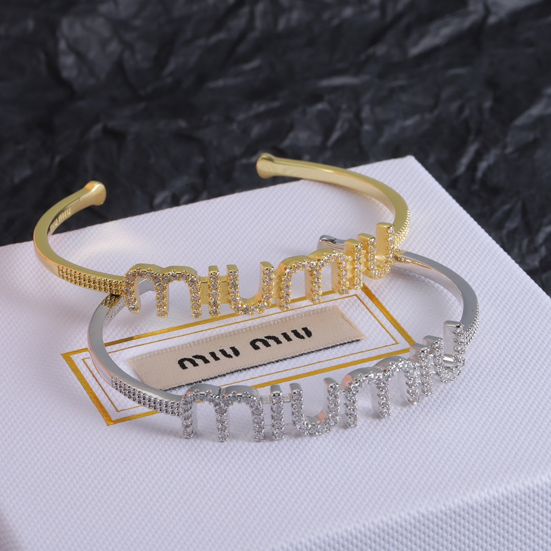 Gold and white-gold open bangles with diamond zigzag rows