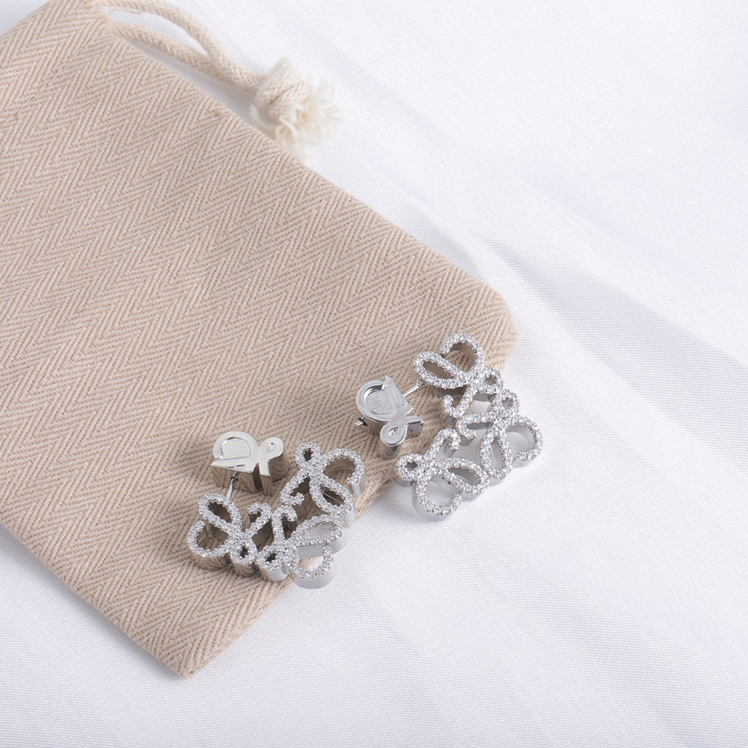 White gold geometric hollow diamond stud earrings with four-petal cluster design