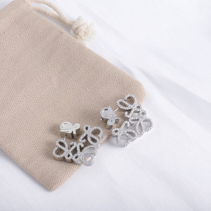White gold geometric hollow diamond stud earrings with four-petal cluster design